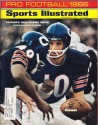 Sammy Baugh hands off to Gayle Sayers - Pro Football Issue